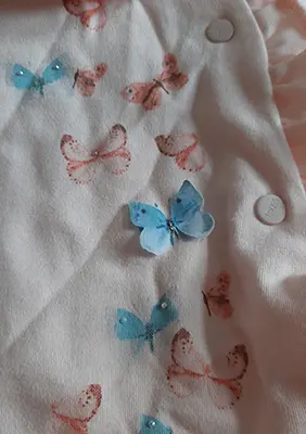 Photo from the official notice: Tongs baby baby's bodysuit — choking risk
