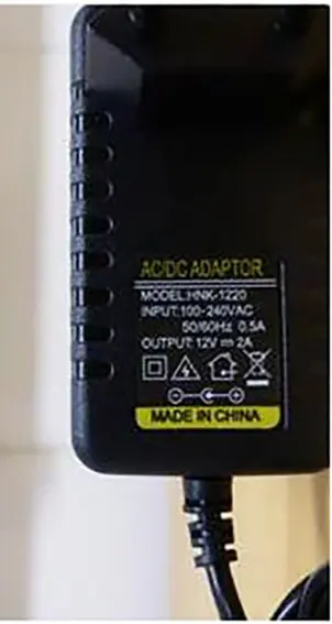 Photo from the official notice: US UK EU DC 12 V 2A- Adaptateur d'alimentation à découpage - Adaptateur de bande lumineuse LED mains adaptor — electric shock risk