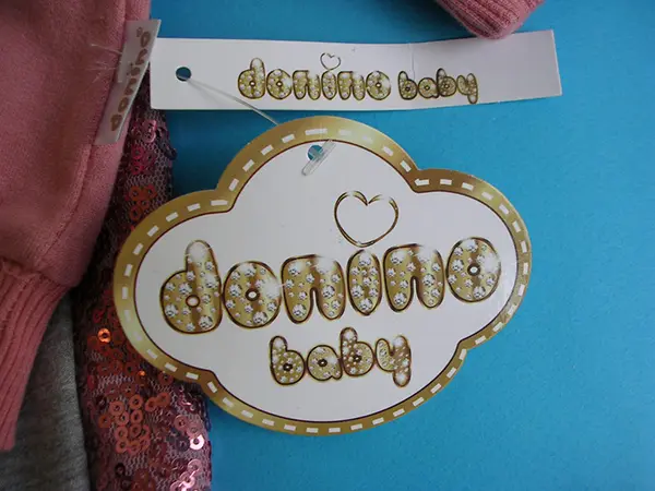 Photo from the official notice: Donino Baby babies' clothing set — choking risk