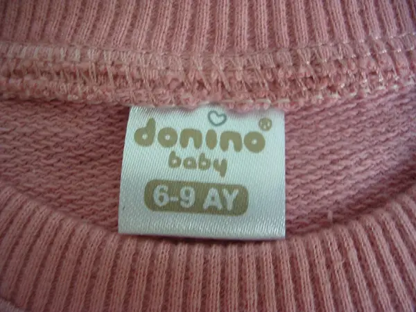 Photo from the official notice: Donino Baby babies' clothing set — choking risk