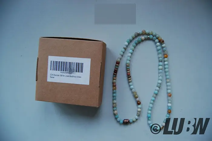 Foto aus der offiziellen Meldung: COAI coai Unisex 108 Mala aus Vielfärbig Amazonit mit BuddhaKopf Armband — Risiko: Chemikalie