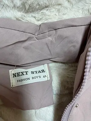 Foto uit de officiële melding: NEXT STAR Kinderjasje — risico: Verwonding