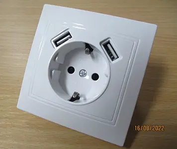 Photo from the official notice: In-wall socket — electric shock & fire risk