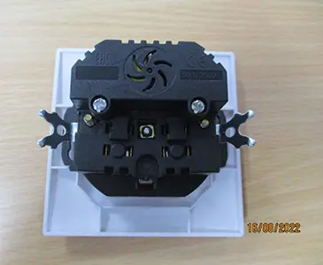 Photo from the official notice: In-wall socket — electric shock & fire risk