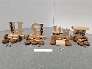 Photo from the official notice: Bino Europe k.s. Locomotive brown wheels, train wagon letter U with brown wheels, train wagon letter R toy tra — choking risk