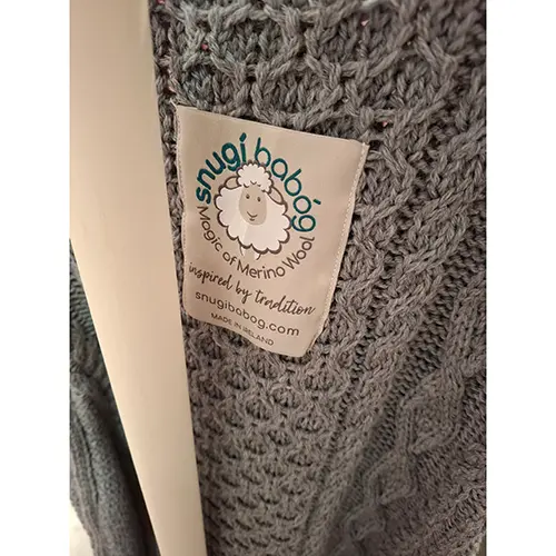 Photo from the official notice: Snugí Knitwear Luxury Aran Knitted Baby Sleeping Bag in Super-Soft Italian Merino Wool with Side Zip Opening — suffocation risk