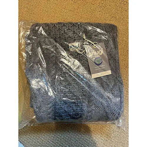 Photo from the official notice: Snugí Knitwear Luxury Aran Knitted Baby Sleeping Bag in Super-Soft Italian Merino Wool with Side Zip Opening — suffocation risk