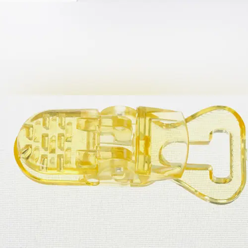 Foto aus der offiziellen Meldung: Clip attache tetine Jaune en plastique Schnullerhalter — Risiko: Ersticken durch Sauerstoffmangel
