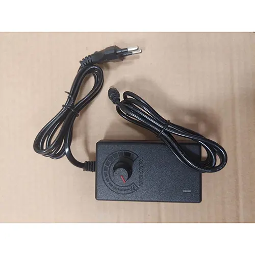 Foto aus der offiziellen Meldung: Adaptateur d'alimentation réglable AC 220V 110V à DC 3V 9V 12V 24V 36V, adaptateur universel 220 110 Adapter — Risiko: Elektrischer Schlag