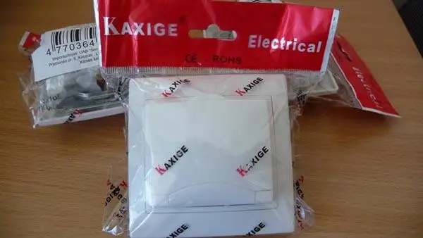 Photo from the official notice: KAXIGE mains wall socket — electric shock & fire risk