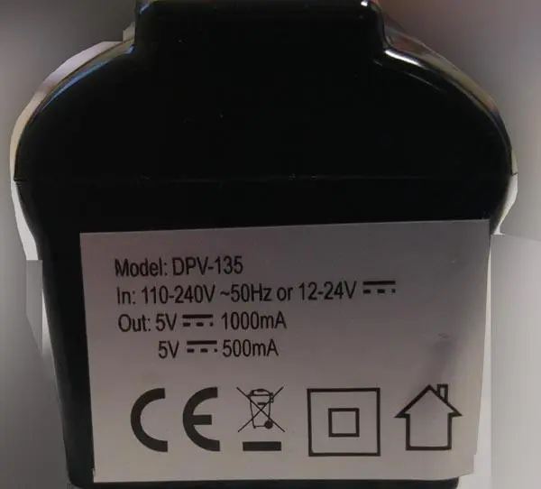 Photo from the official notice: COMUTECH Adaptateur allume-cigare ('Cigarette-lighter adapter') — electric shock & fire risk