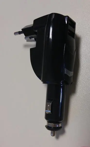 Photo from the official notice: COMUTECH Adaptateur allume-cigare ('Cigarette-lighter adapter') — electric shock & fire risk