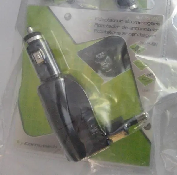 Photo from the official notice: COMUTECH Adaptateur allume-cigare ('Cigarette-lighter adapter') — electric shock & fire risk
