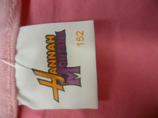 Foto del aviso oficial: Hannah Montana (THE PRODUCT MAY BE COUNTERFEIT) La parte superior de las chicas — riesgo: Estrangulamiento (A12/1285/12)