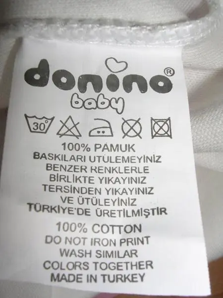 Foto do aviso oficial: Donino Roupa de bebé — risco: Engasgamento & Ferimentos