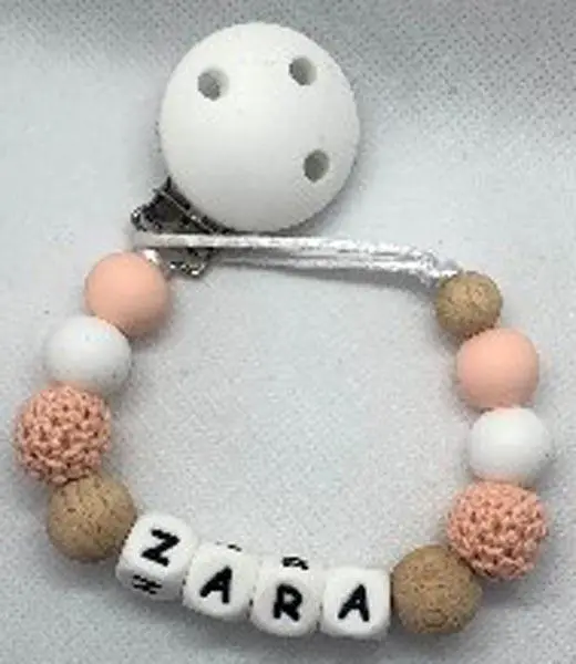 Foto uit de officiële melding: Calbabyco Silicone bead with Wooden teething ring Bijtring — risico: Verstikking door inslikken