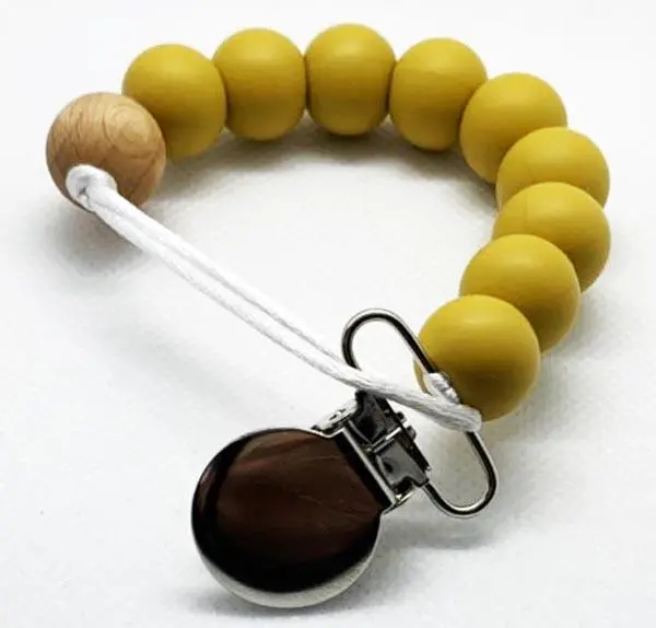 Foto uit de officiële melding: Calbabyco Silicone bead with Wooden teething ring Bijtring — risico: Verstikking door inslikken