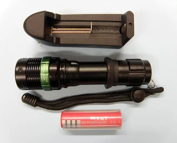 Photo from the official notice: H.Z.M (on the battery charger) POWER STYLE torch with battery charger — electric shock risk