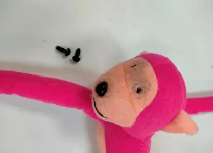 Photo from the official notice: 1Pcs Soft Filled Pink Long Arm Monkey Toy sold via Wish — choking risk