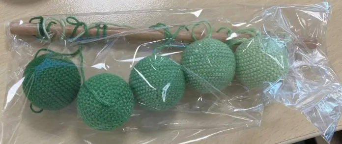 Photo from the official notice: Montessori Cot Mobile with Five Green Hanging Balls sold via AliExpress — strangulation risk