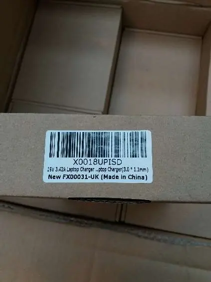 Photo from the official notice: 65W AC Adapter for Laptop — burns risk