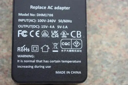 Photo from the official notice: 65W AC Adaptor, DHM1706 sold via Amazon — fire risk
