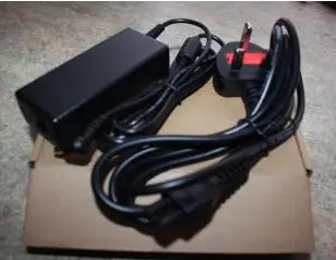 Photo from the official notice: AC/DC Power Adapter PC120050 — fire & burns risk