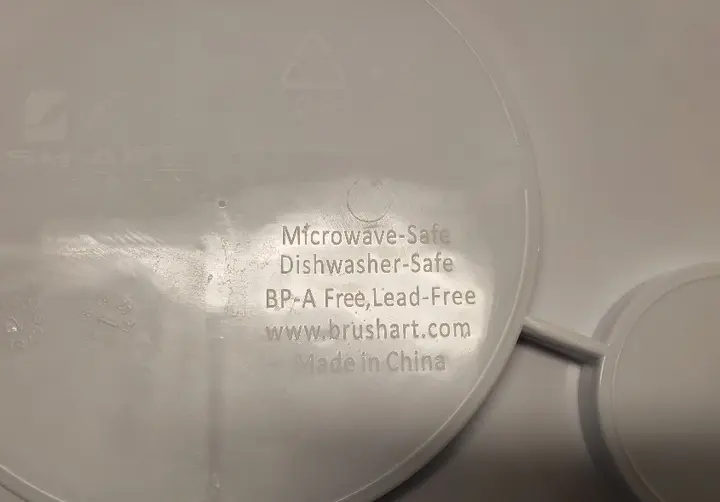 Back of WIC Nutrition Plate - safety label, Brush Art website, and location of manufacture