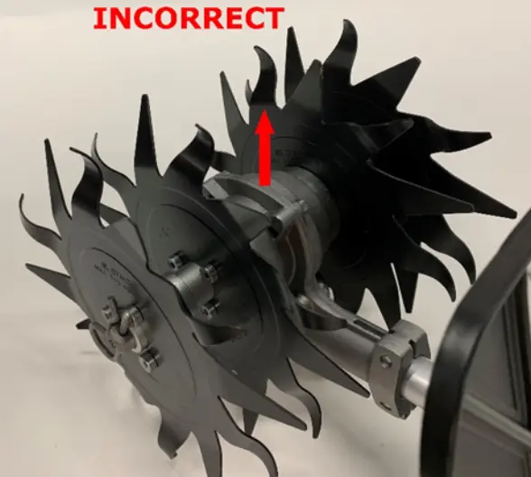 Recalled mini-cultivator attachment. Close-up of gearbox mounted upside down so that the axle is above the drive tube.