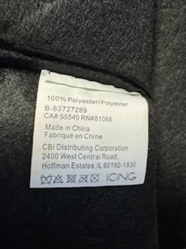 "CBI Distributing Corporation" is printed on the sewn-in tag inside the hat