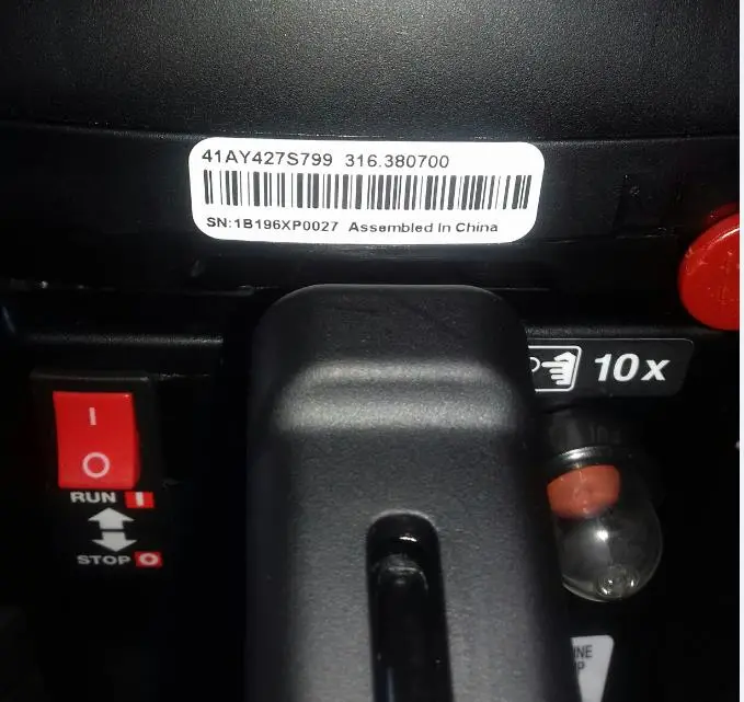 Model and serial numbers and the manufacture date are located on a white label above the rear handle.
