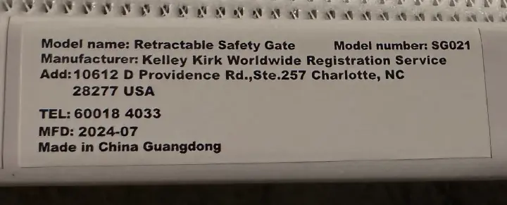 Retractable Safety Gate and "Model number: SG021" are printed on a white label located on the inside of the gate's frame.