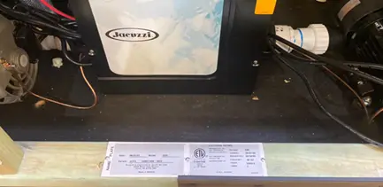 Location of the model number and serial number inside the equipment bay of the hot tub