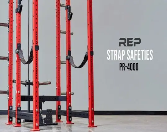 PR-4000 Strap Safety Brackets attached to the weight lifting posts of a squat stand