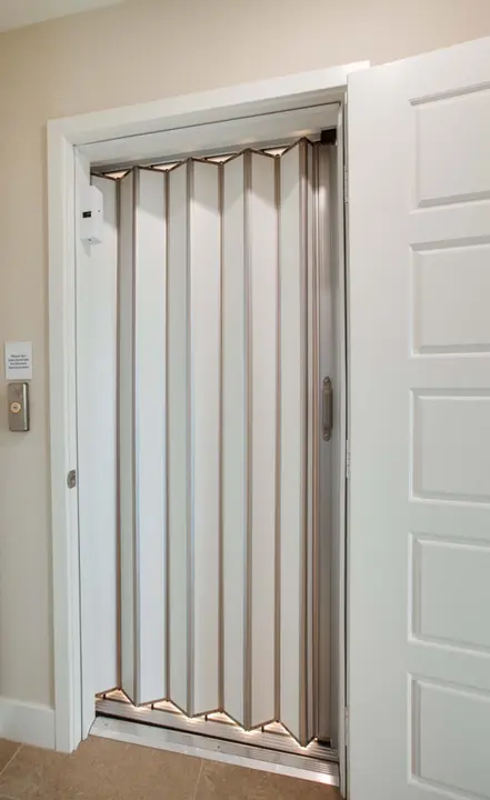 The door to the elevator generally matches all other doors in the home. The elevator gate may be open metal lattice or a solid folded sliding door.