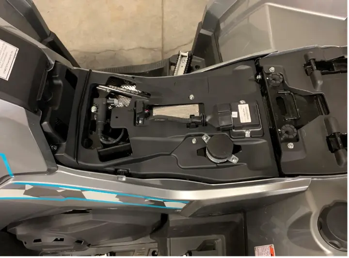 The VIN is stamped on the frame rail located on the right side, under the seat