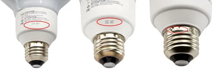 Date codes are printed on the white ceramic area or stamped in the gold metal at the base of the lamps.