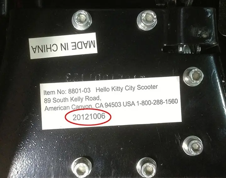 The model number and the manufacture date are printed on a label on the underside of the scooter