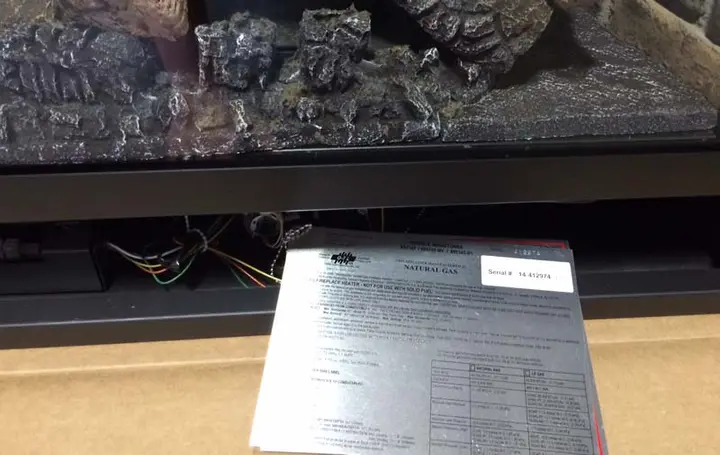 The testing label is next to the gas valve of the fireplace or fireplace insert.