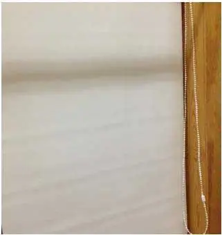 Recalled Carra Imports roller shade with a continuous loop bead chain