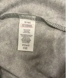 Sewn-in, side-seam label states size, "Not Intended for Sleepwear," "RN 15741," the fiber content, "Made in China," and washing instructions