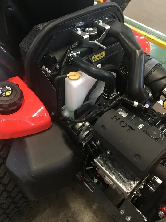 The coolant reservoir is white with a yellow cap.