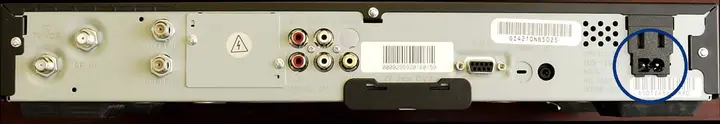 Back of the recalled Motorola DCT2000 cable set-top box with the power cord pins circled