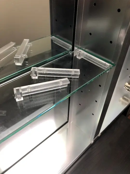 One-piece bracket system for inner shelves on recalled medicine cabinets