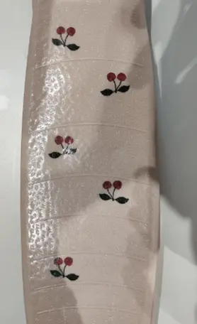 Close-up of Cherry print on the Recalled Konges Sløjd Scooter – model KS101544-P00005