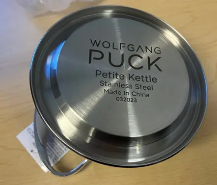 Wolfgang Puck Petite Kettle appears on the kettle's underside