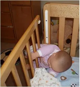 Recalled crib with baby trapped