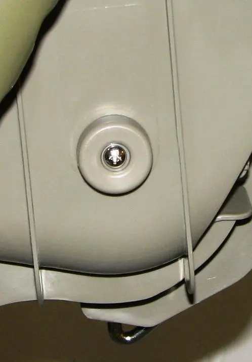 Plastic cap and screw on side of chair